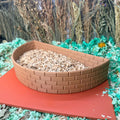 Curved brick wall hamster dig box filled with substrate