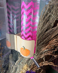Magnetic pumpkin water bottle holder attached to a hamster enclosure wall